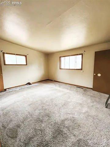 an empty room with a empty space and windows