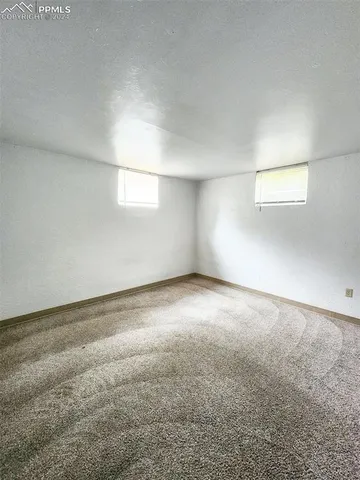 an empty room with a empty space and windows