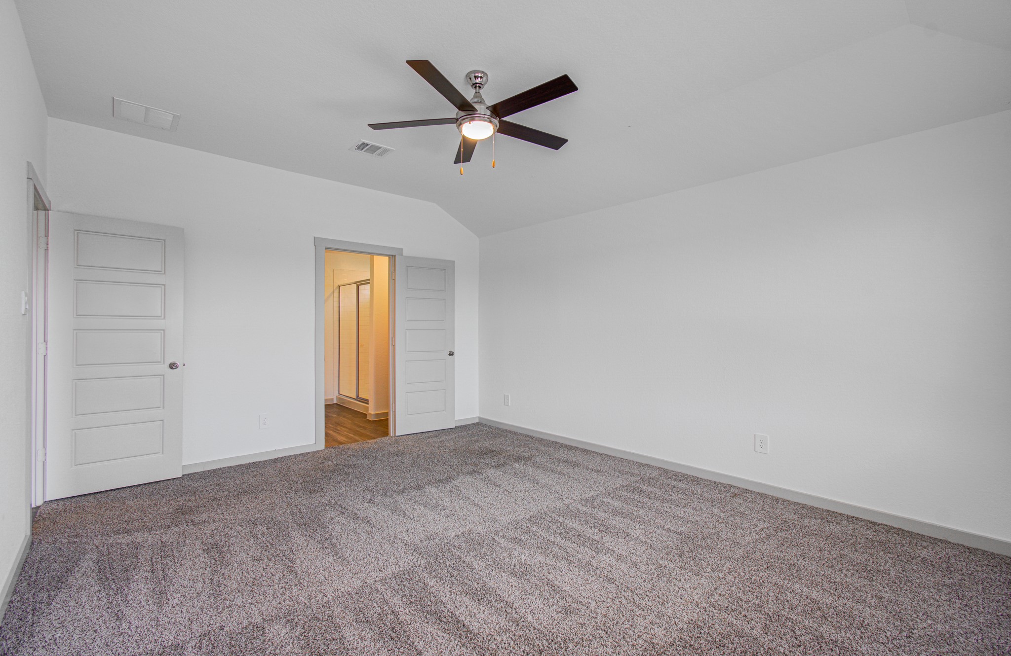 7903 Wrangler Shack Lane Rosharon, TX 77583 - Photo 25 of 29 This spacious, carpeted bedroom boasts neutral walls, a ceiling fan, and offers the ultimate convenience with direct access to both a bathroom and a walk-in closet.