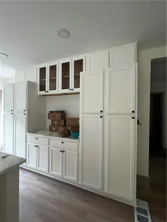 a kitchen with stainless steel appliances a refrigerator and cabinets