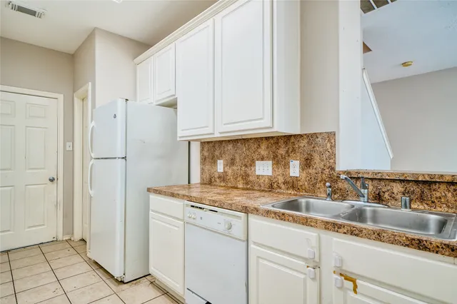 a kitchen with appliances cabinets and a counter top space