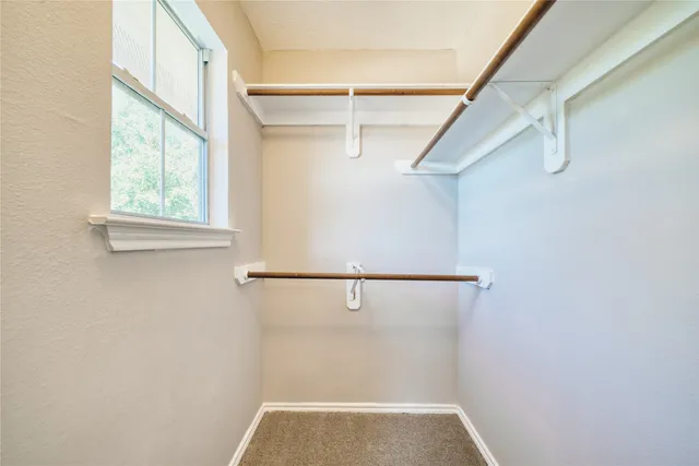 a view of an empty room and a window