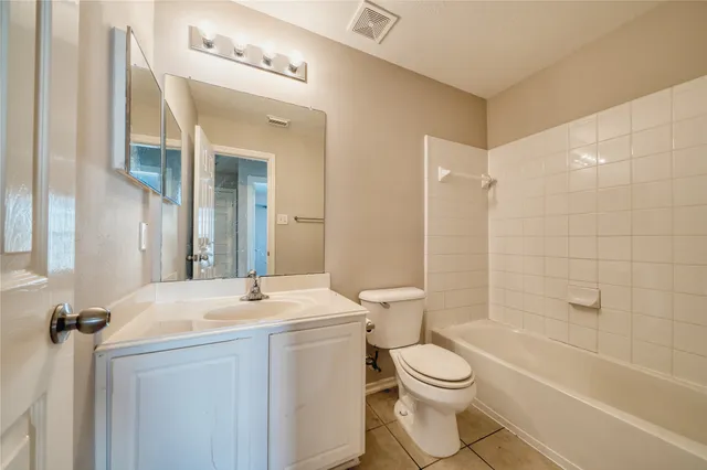 a bathroom with a sink toilet and mirror