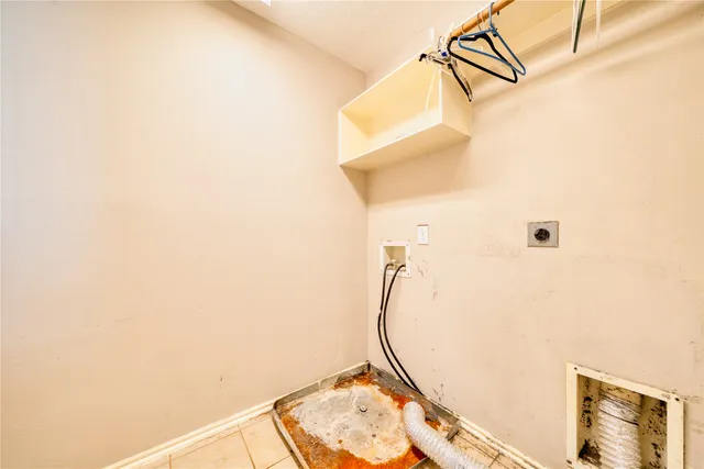 an empty room with windows and chandelier fan