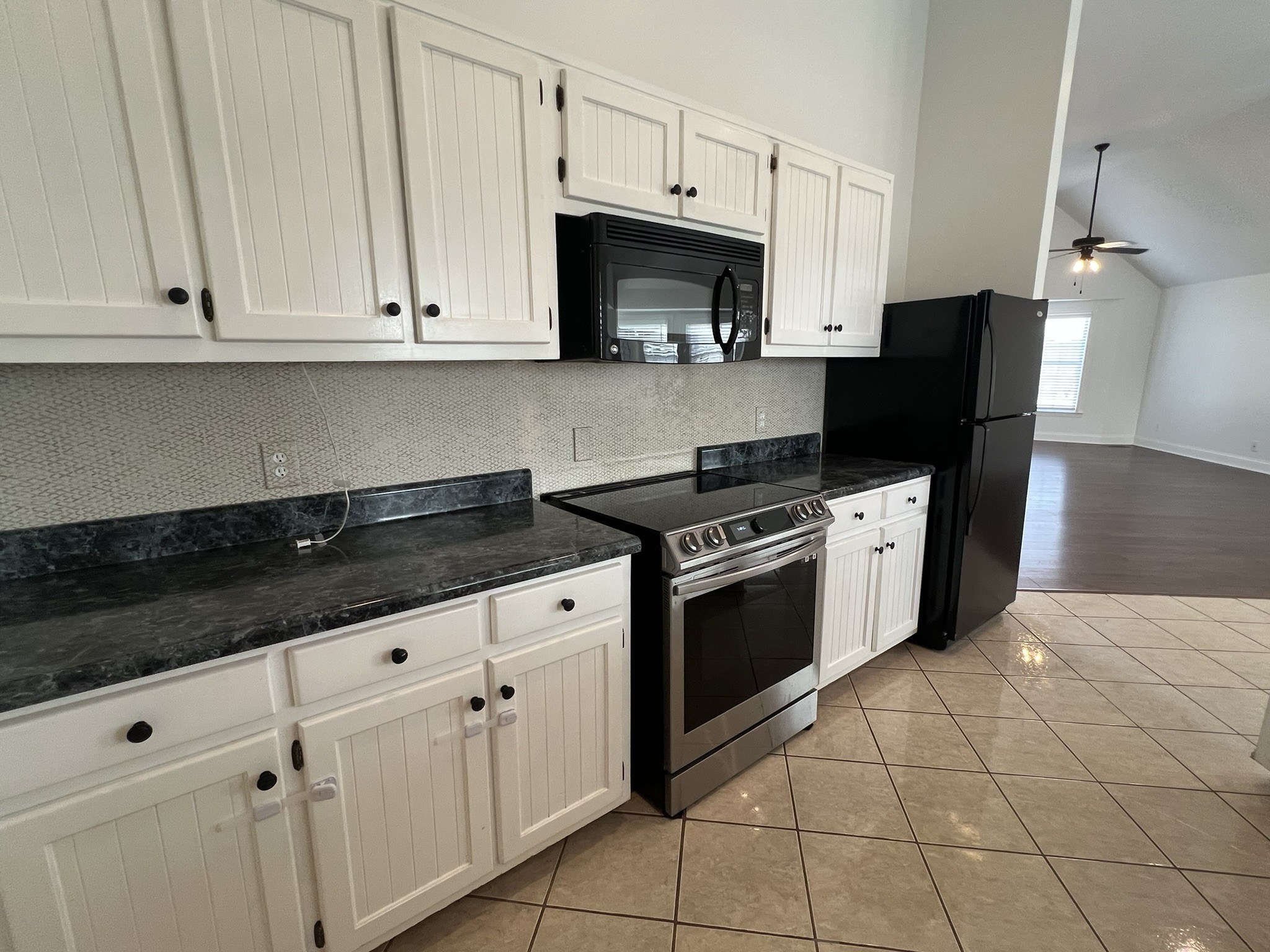 2654 Crosspark Drive Murfreesboro, TN 37129 - Photo 13 of 36 a kitchen with granite countertop white cabinets and stainless steel appliances