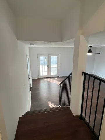 a view of a room with wooden floor and staircase