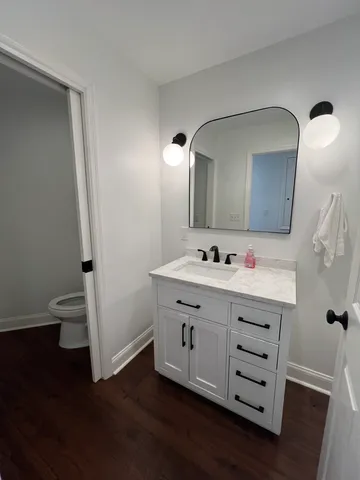 a bathroom with a toilet and a fan