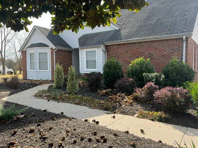 a front view of a house with garden