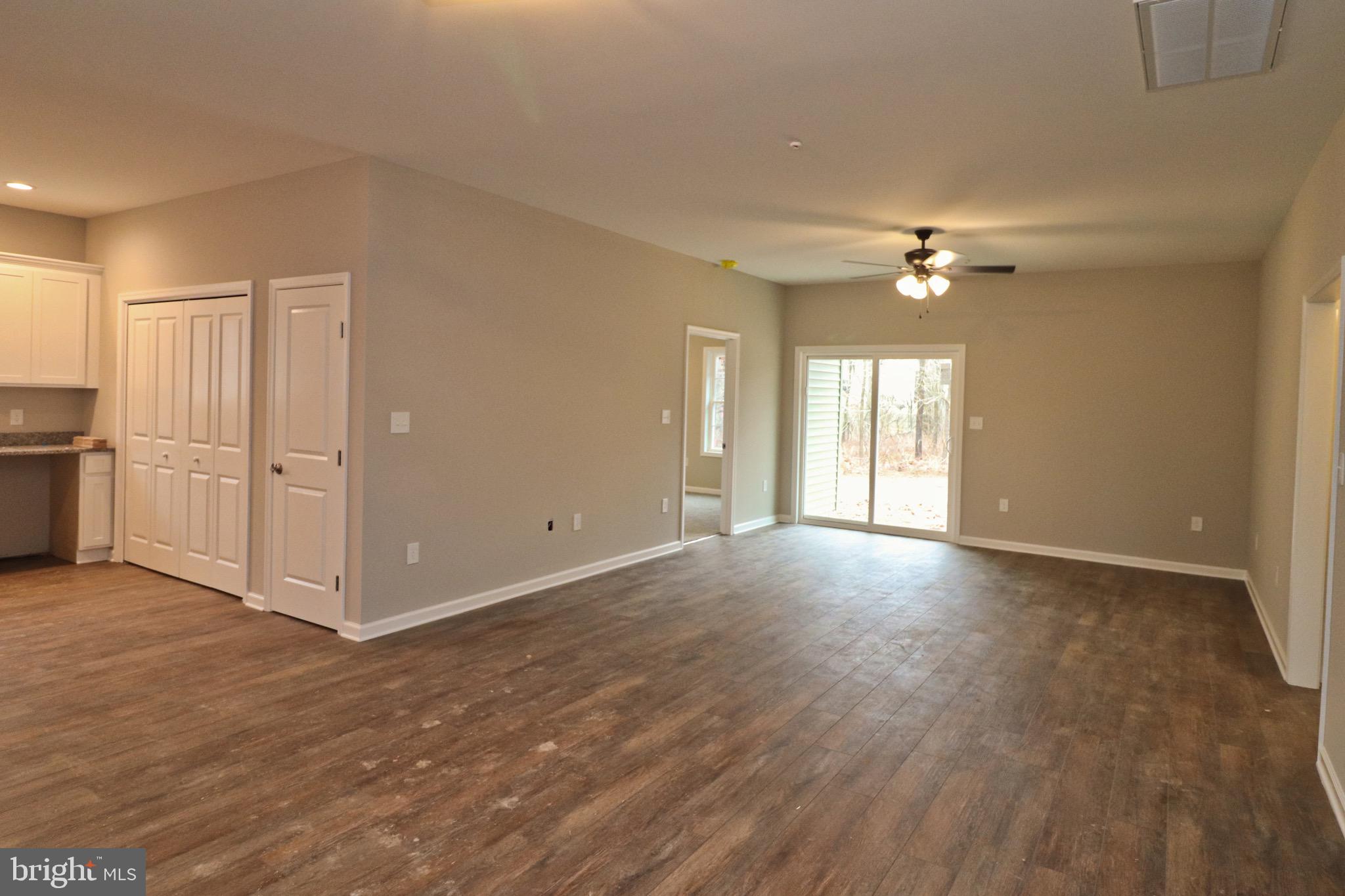 30576 Skipjack Circle, Unit 47 Princess Anne, MD 21853 - Photo 5 of 11 an empty room with windows and ceiling fan