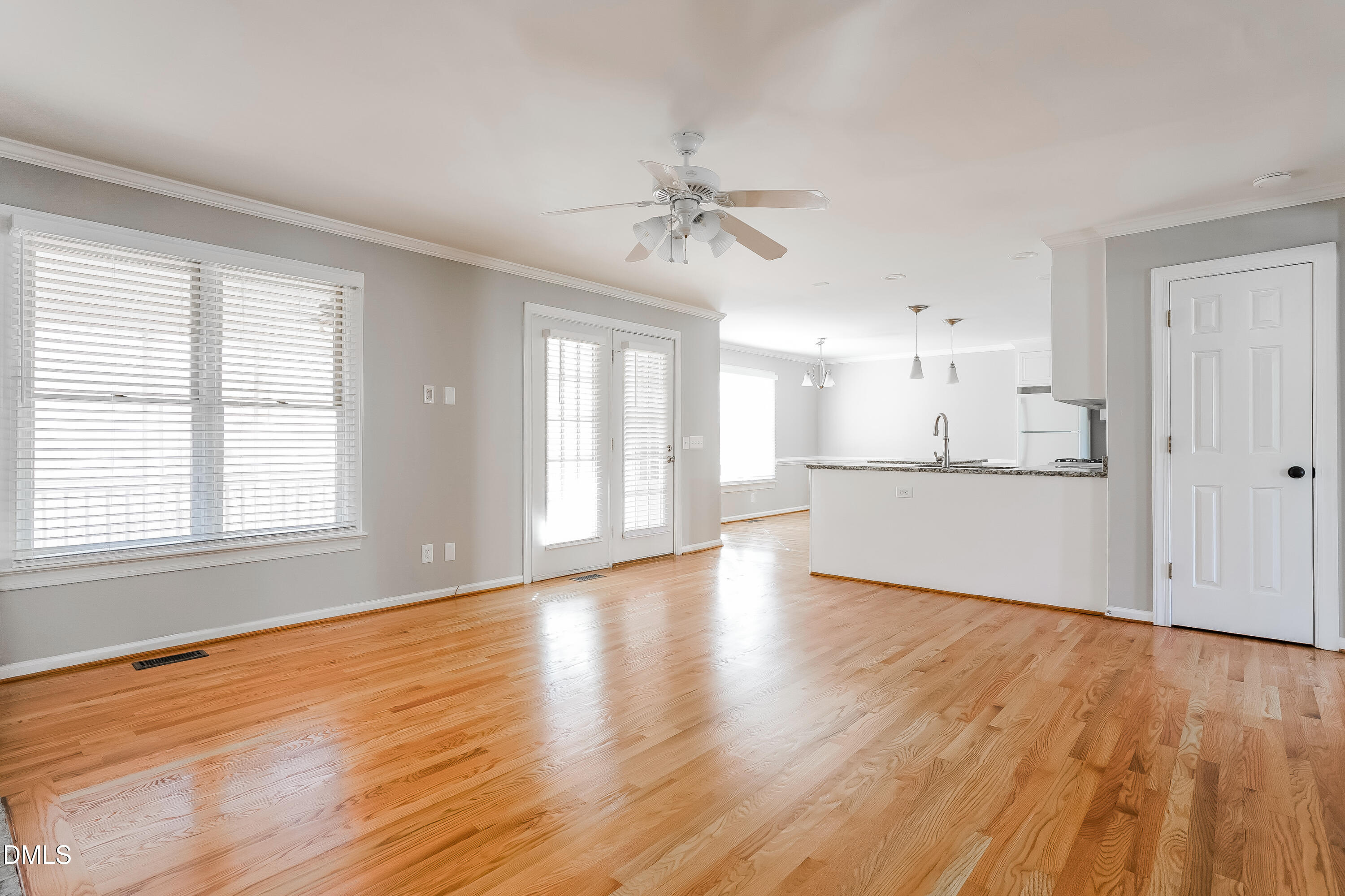 17 Edinburgh Place Clayton, NC 27527 - Photo 2 of 17 a view of a kitchen and an empty room with wooden floor and a window