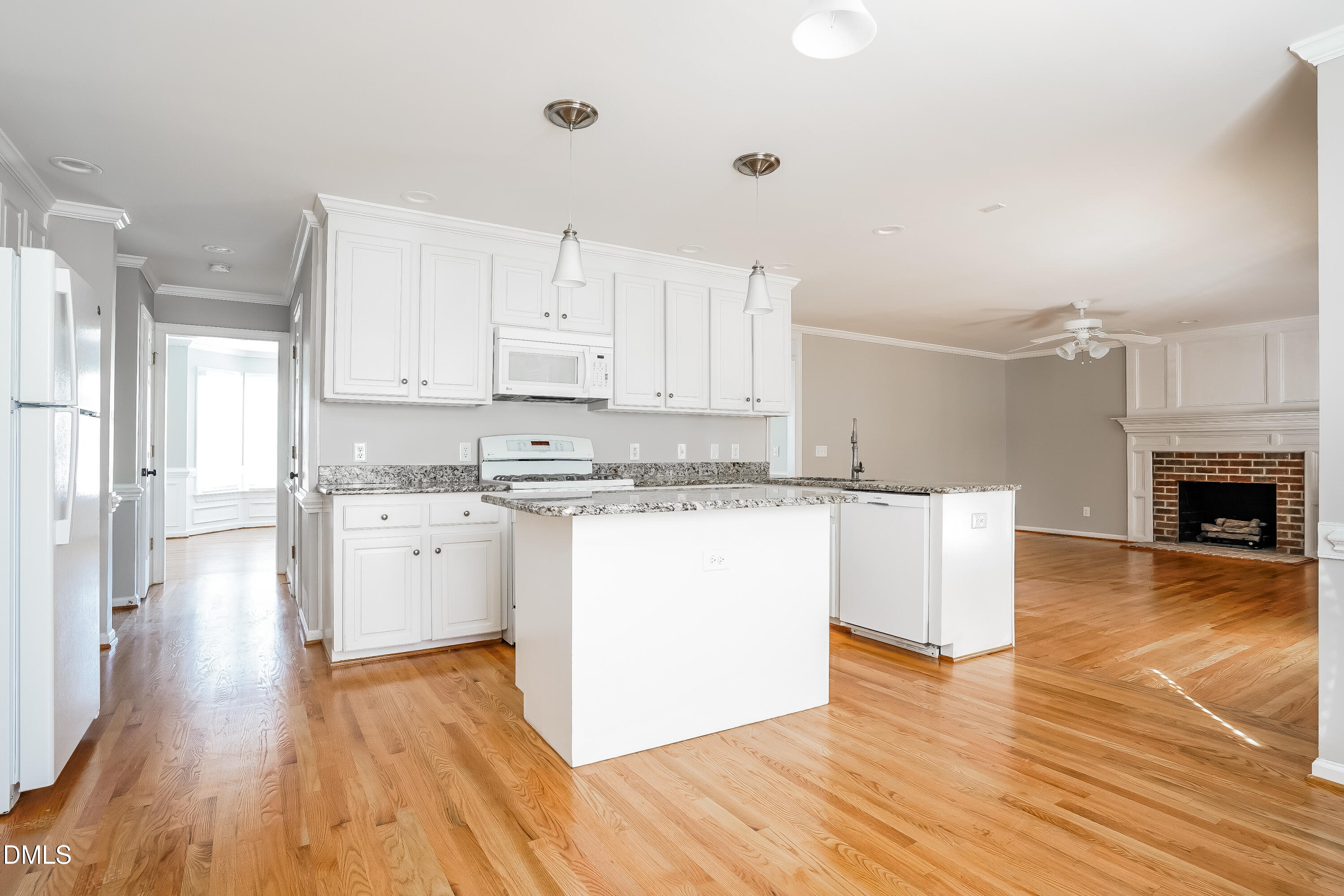 17 Edinburgh Place Clayton, NC 27527 - Photo 6 of 17 a kitchen with wooden floors and white cabinets