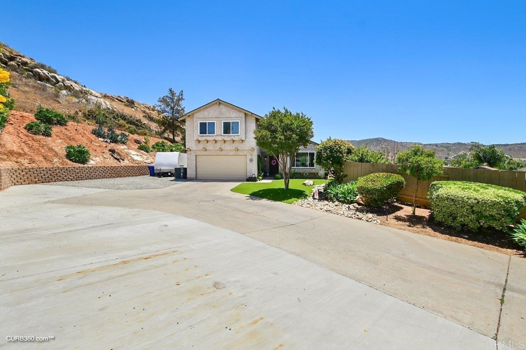 9631 Ramsgate Way Santee, CA 92071 - Photo 1 of 1 a front view of a house with a yard and garage