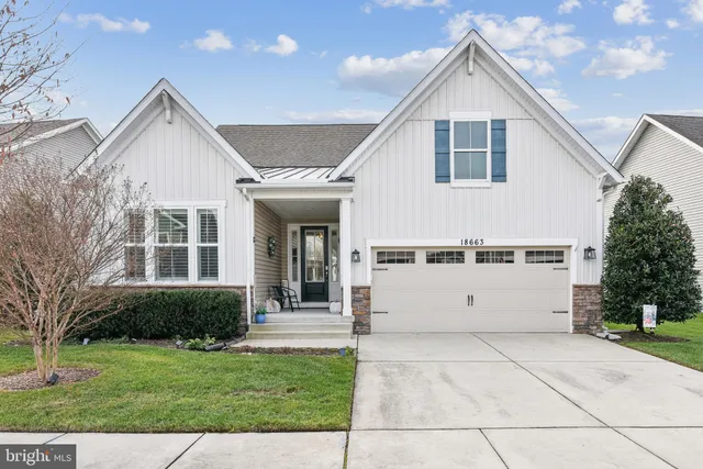 a view of a white house with a yard