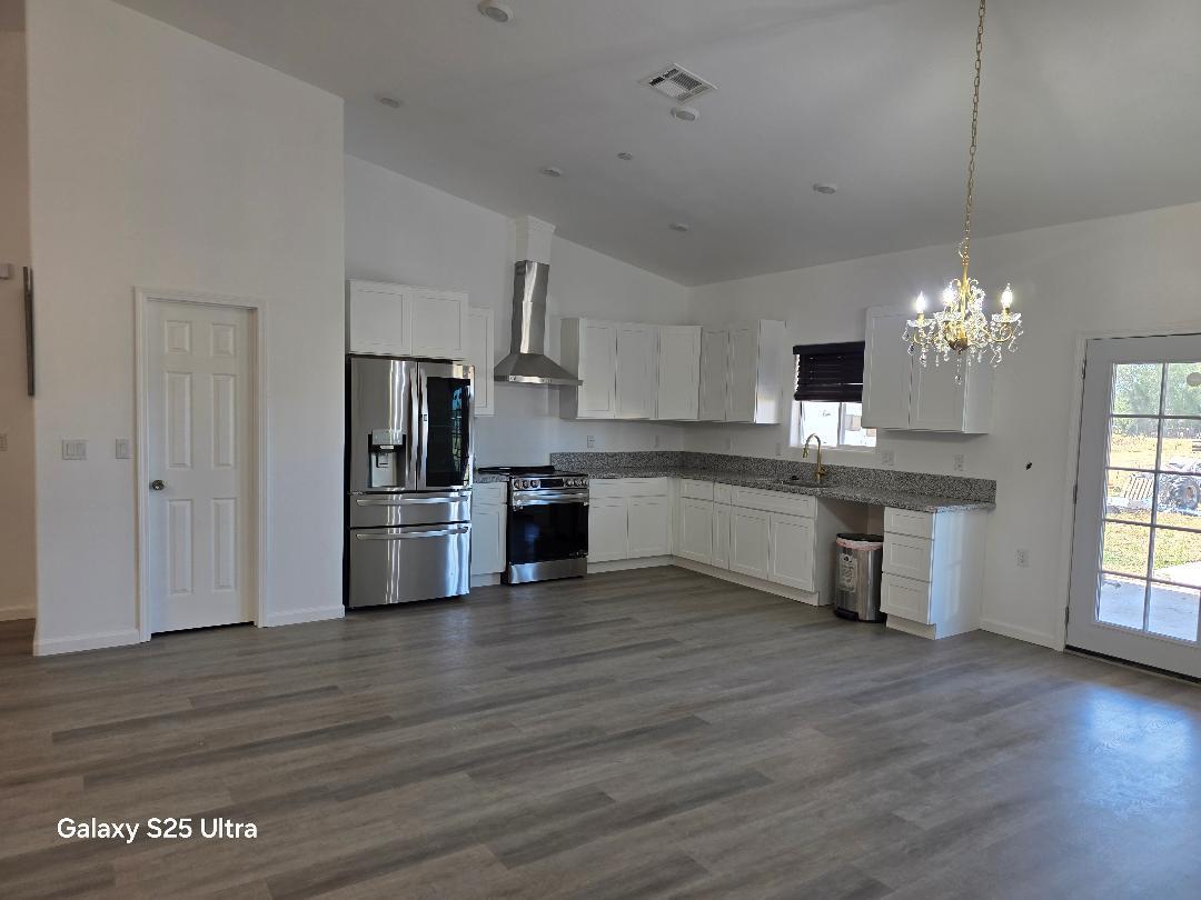 36768 Verde Avenue Madera, CA 93636 - Photo 7 of 17 a kitchen with stainless steel appliances a refrigerator sink and cabinets