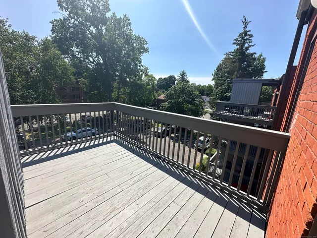 a balcony with wooden floor