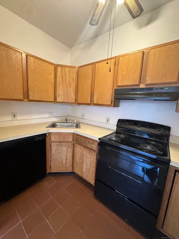 a kitchen with a sink stove and cabinets