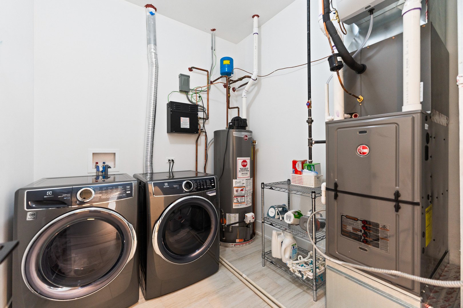 1767 West Rosehill Drive, Unit 304 Chicago, IL 60660 - Photo 29 of 36 a view of a storage and utility room with water heater and wooden floor