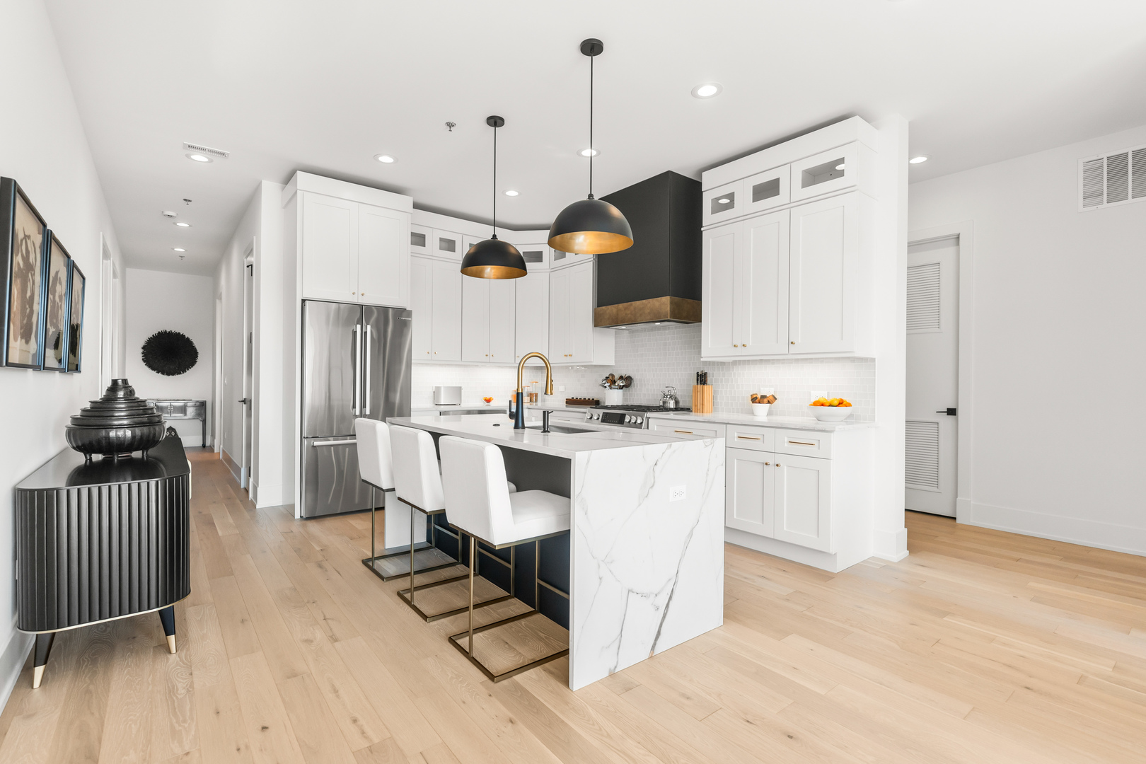 1767 West Rosehill Drive, Unit 304 Chicago, IL 60660 - Photo 8 of 36 a kitchen with white cabinets and stainless steel appliances