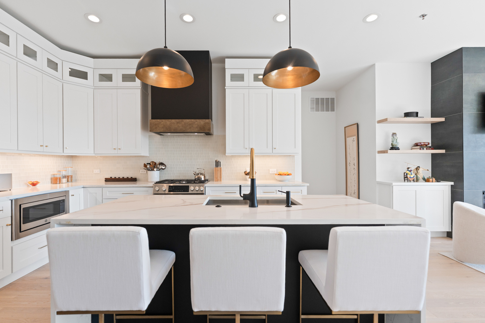 1767 West Rosehill Drive, Unit 304 Chicago, IL 60660 - Photo 9 of 36 a kitchen with stainless steel appliances granite countertop a sink a stove a refrigerator a microwave oven with white cabinets and wooden floor
