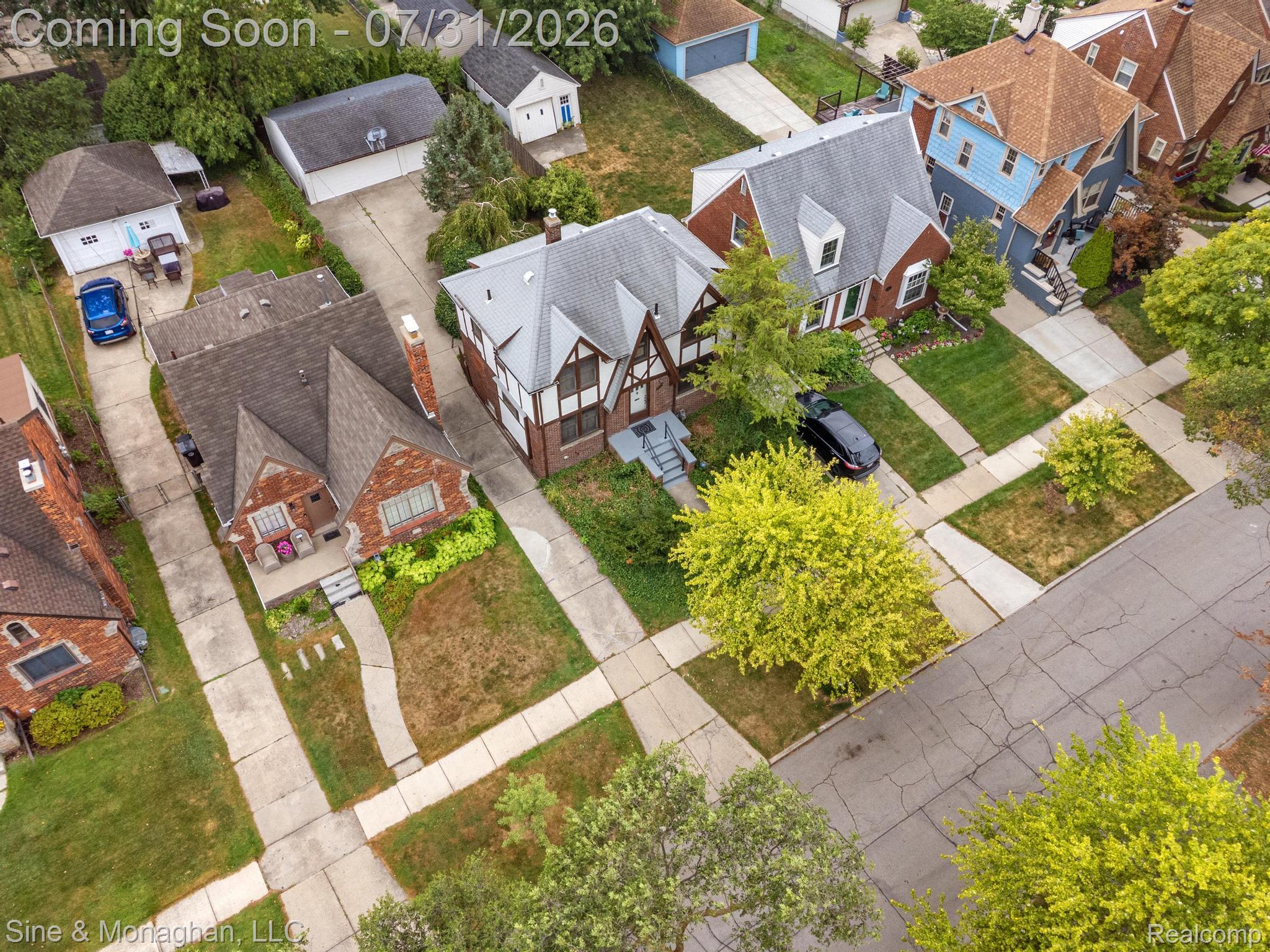 417 Cloverly Road Grosse Pointe, MI 48236 - Photo 59 of 70 Tudor Revival-style home featuring a brick and half-timber facade, prominent gables, a gray shingle roof, and a concrete driveway
