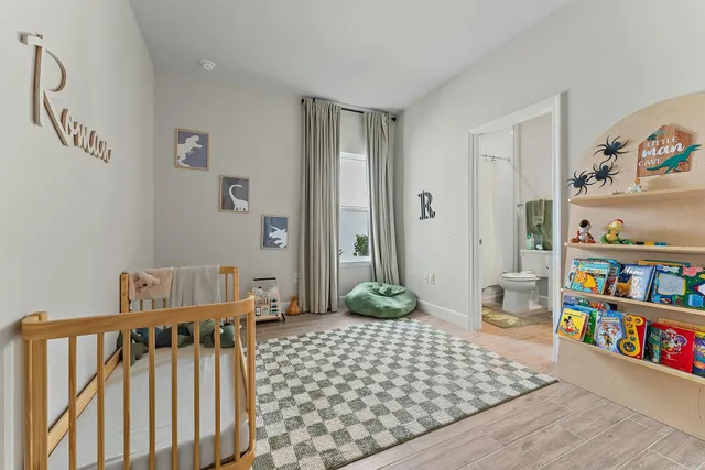 a view of a room with furniture and wooden floor