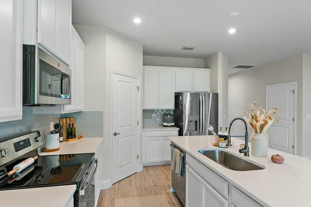 a bathroom with a sink a toilet and a large mirror