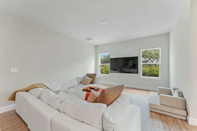an aerial view of a house with swimming pool and outdoor seating