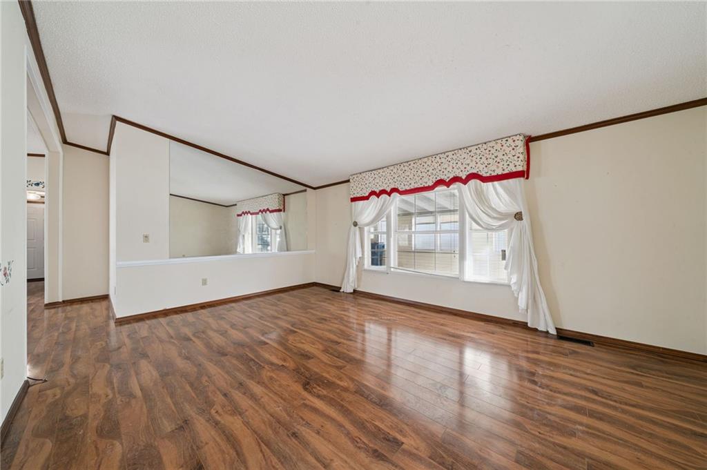 236 Ridge Lane Murrysville, PA 15668 - Photo 3 of 12 a view of an empty room with wooden floor and a window