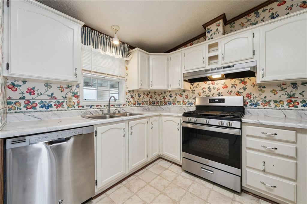 236 Ridge Lane Murrysville, PA 15668 - Photo 5 of 12 a kitchen with stainless steel appliances granite countertop white cabinets and window