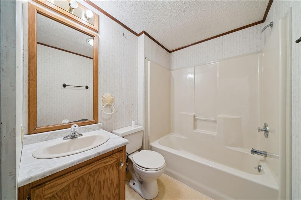 236 Ridge Lane Murrysville, PA 15668 - Photo 10 of 12 a bathroom with a granite countertop sink toilet and shower