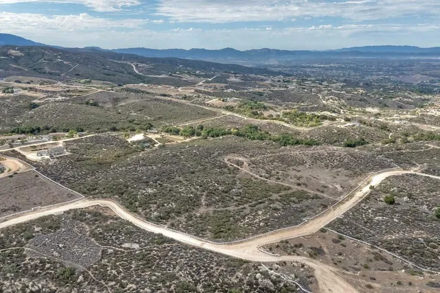 a view of a yard with wooden fence