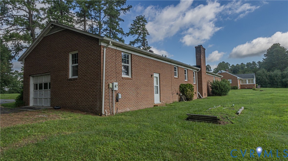 309 Old Plank Road Kenbridge, VA 23944 - Photo 9 of 45 Brick exterior with multiple windows, attached gar