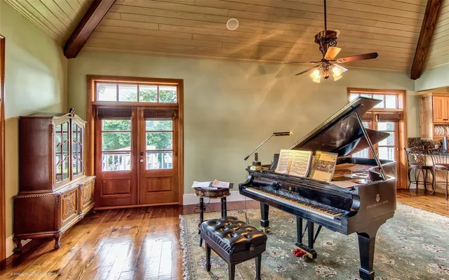 a living room with furniture and a piano