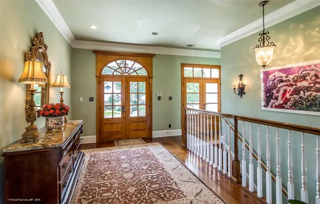 a view of a hallway with wooden floor and a book shelf