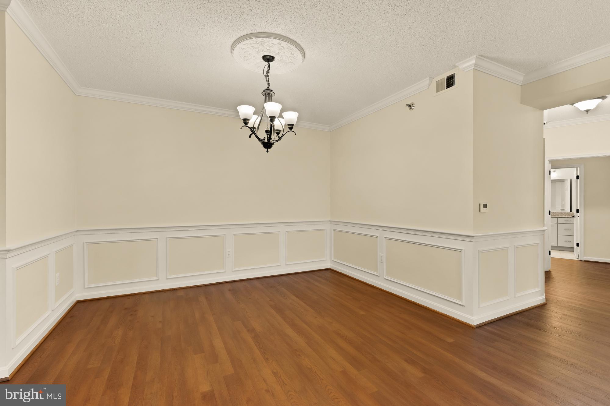 3005 South Leisure World Boulevard, Unit 201 Silver Spring, MD 20906 - Photo 11 of 38 a view of an empty room with wooden floor