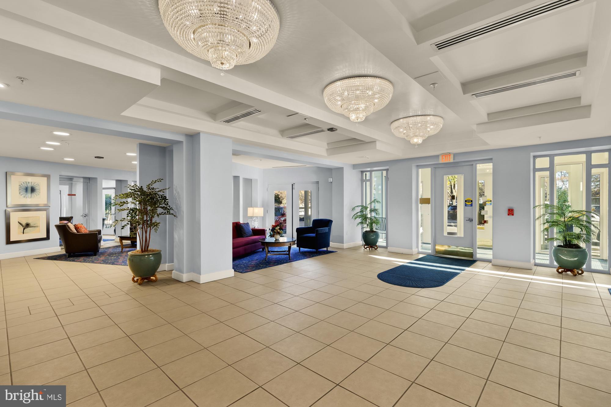 3005 South Leisure World Boulevard, Unit 201 Silver Spring, MD 20906 - Photo 3 of 38 a view of a room with gym equipment and large windows