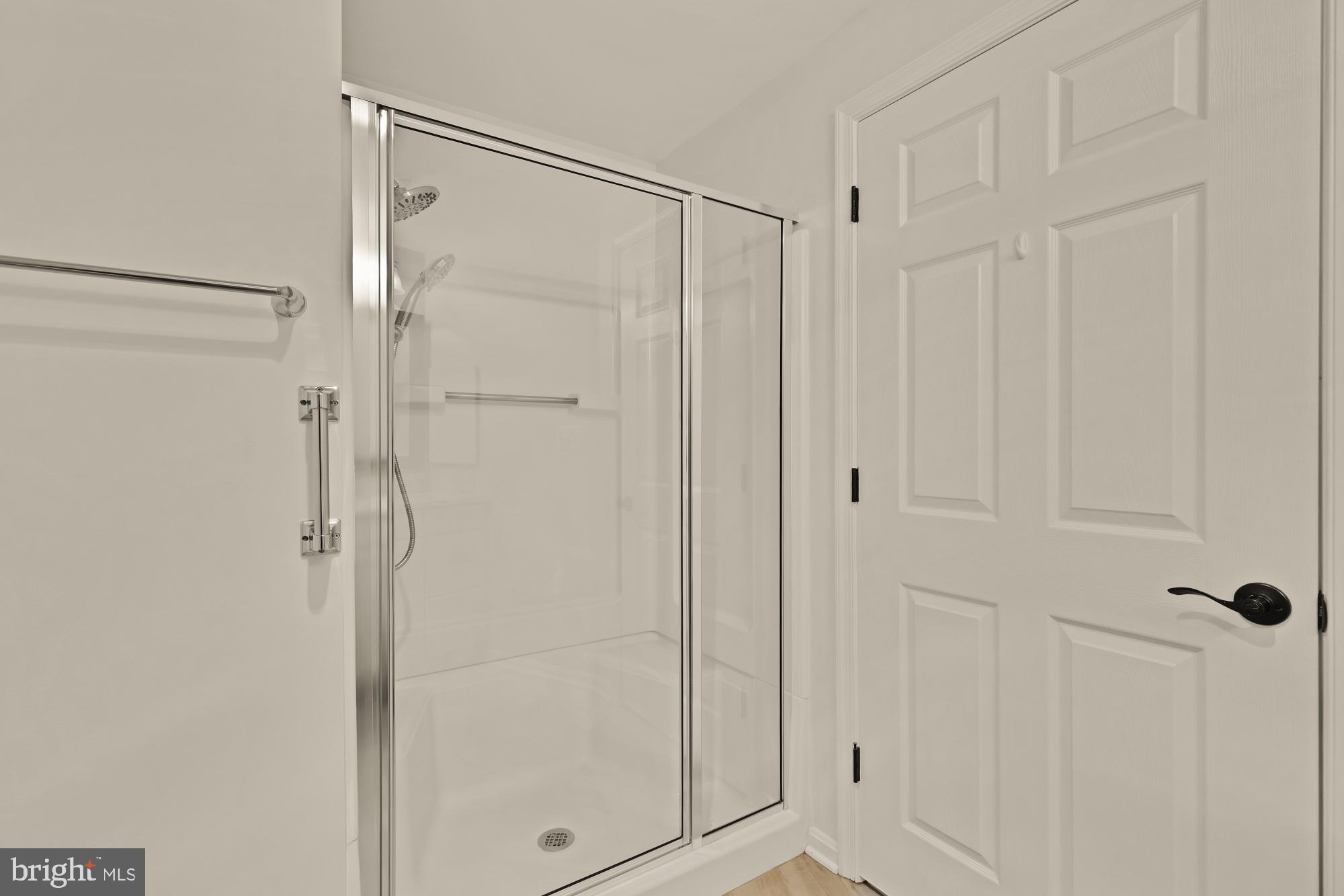 3005 South Leisure World Boulevard, Unit 201 Silver Spring, MD 20906 - Photo 31 of 38 a bathroom with a glass shower door
