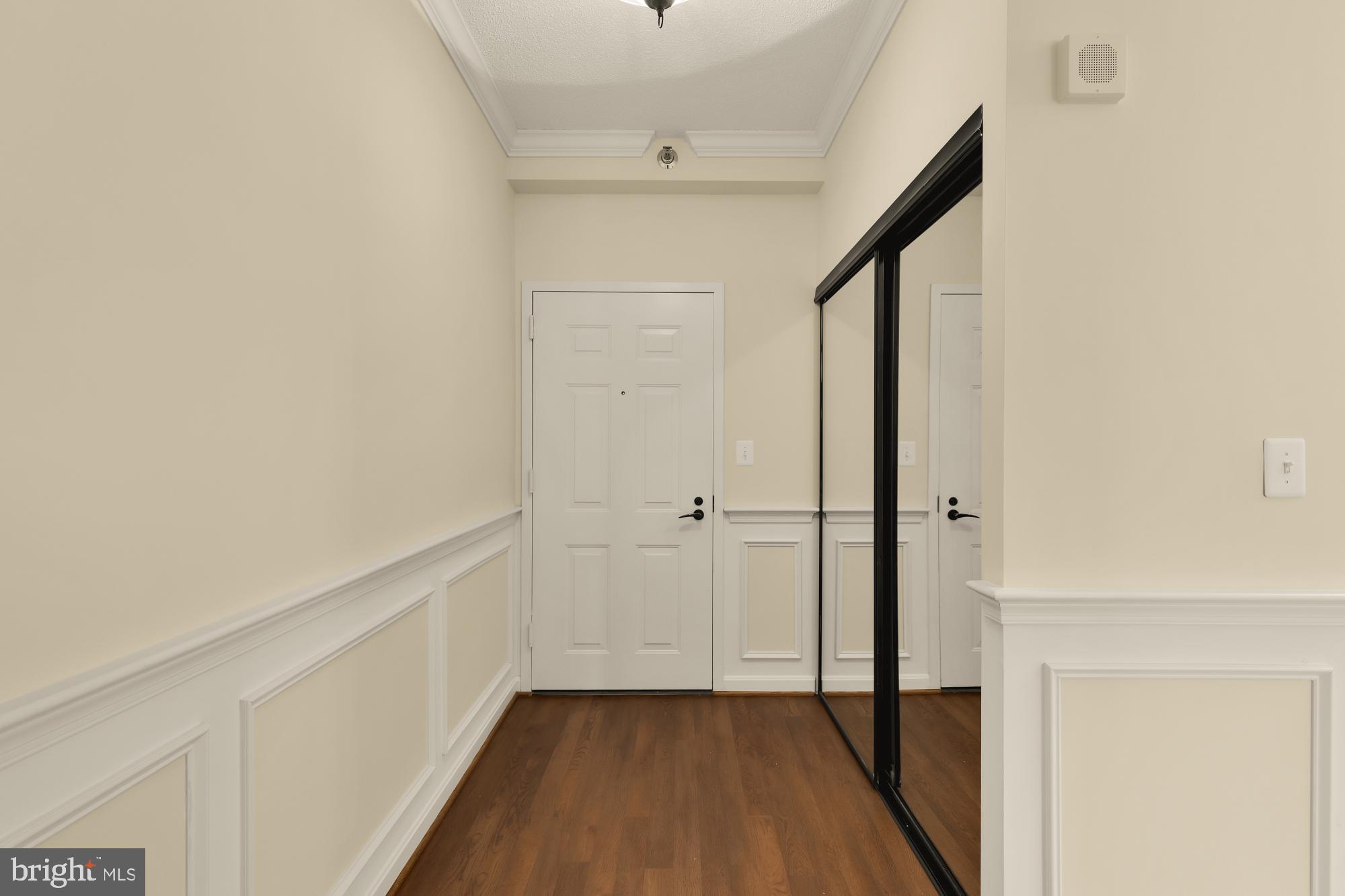 3005 South Leisure World Boulevard, Unit 201 Silver Spring, MD 20906 - Photo 5 of 38 a view of a hallway with wooden floor and entryway