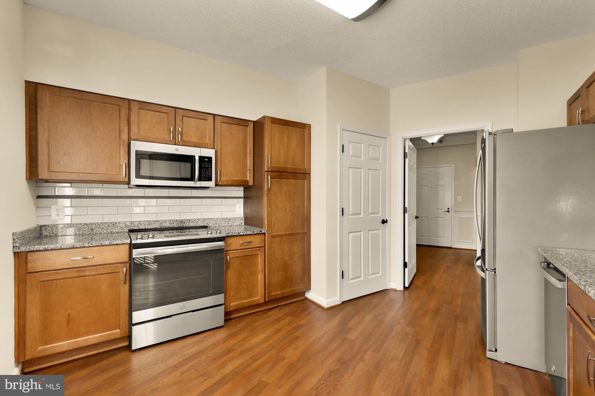 3005 South Leisure World Boulevard, Unit 201 Silver Spring, MD 20906 - Photo 6 of 38 a kitchen with wooden floors appliances and sink