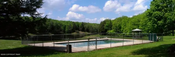 a view of house with swimming pool and garden