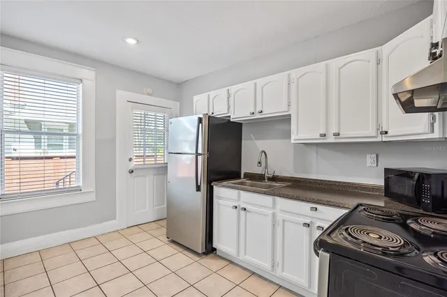 a kitchen with a stove a sink and a refrigerator