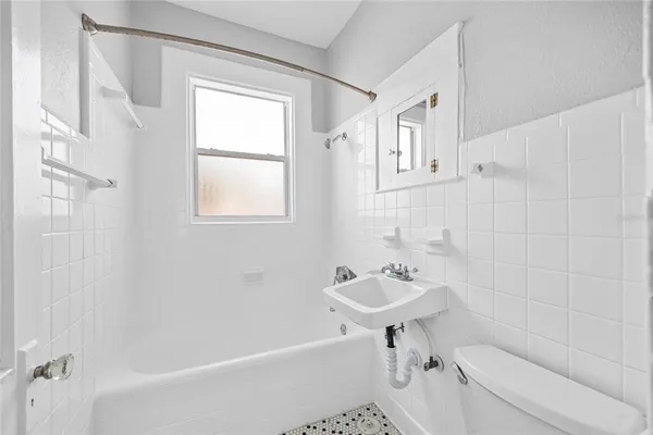 a bathroom with a sink a toilet and a bathtub