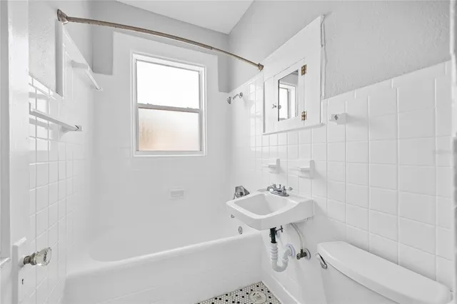 a bathroom with a sink a toilet and a bathtub