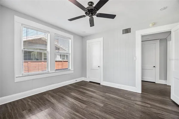 a view of a livingroom with a window and wooden floor