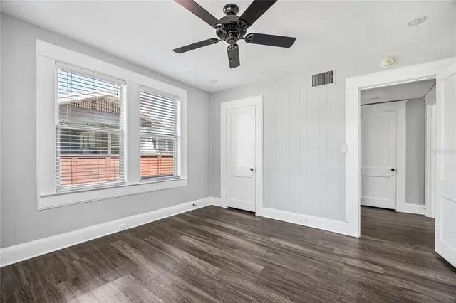 a view of a livingroom with a window and wooden floor