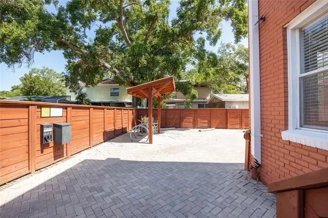 a view of a house with a wooden fence