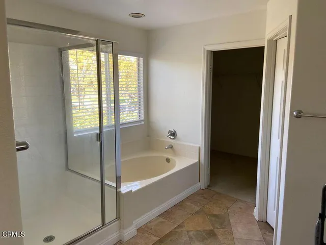 a bathroom with a bathtub and a shower