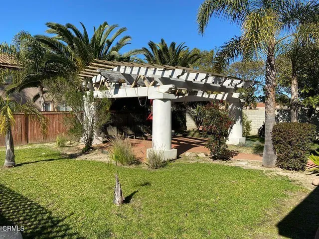 a view of a house with backyard and sitting area