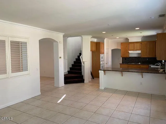a view of a kitchen with furniture and staircase