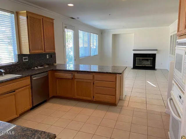a kitchen with stainless steel appliances a sink stove and cabinets